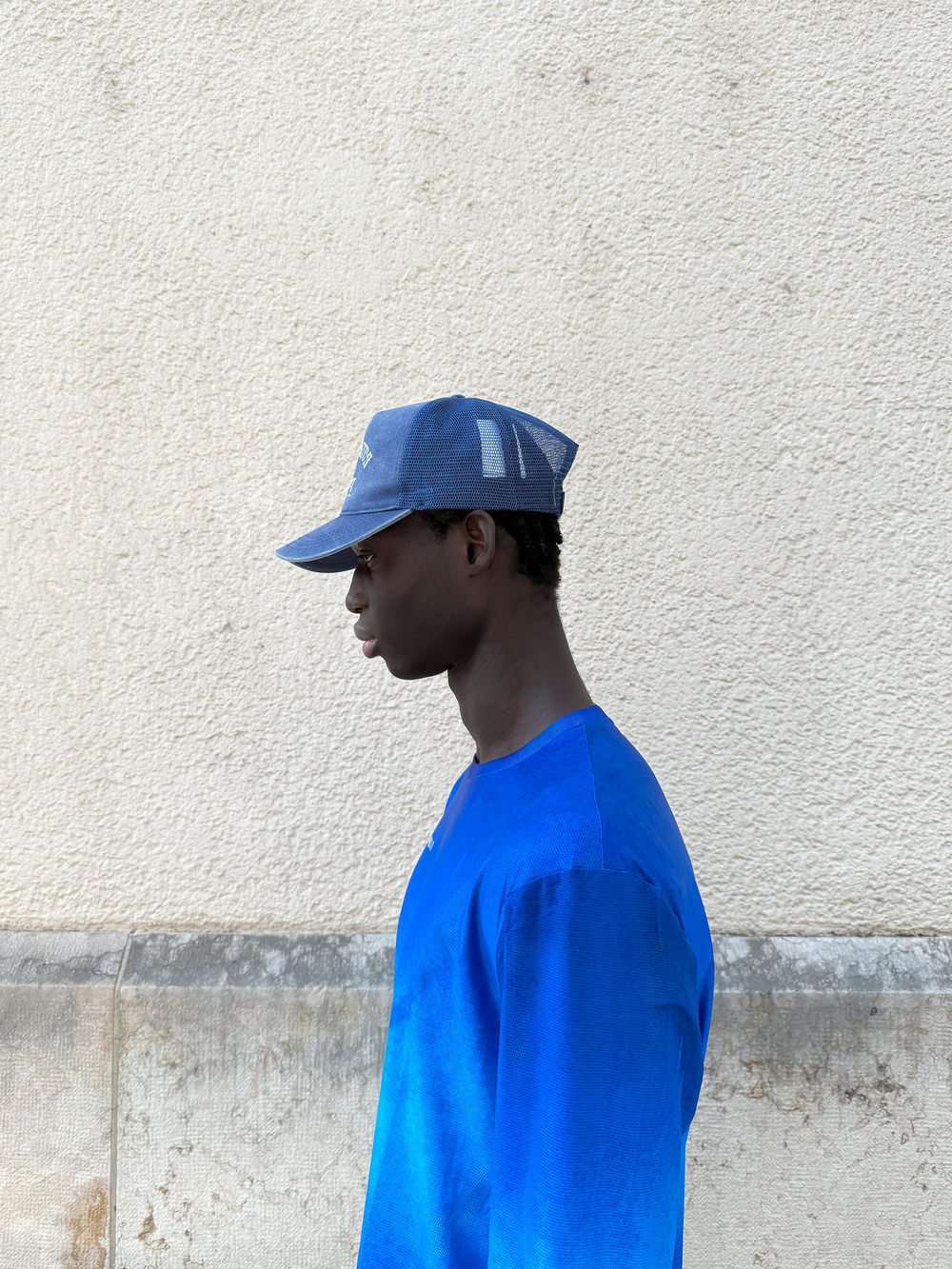 Washed Indigo Mesh Cap by Lievre Running featuring 5 panels and adjustable snapback with vintage Notre-Dame de Paris design.