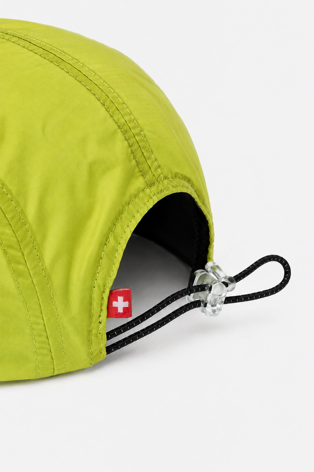 Lievre Running apple green performance running cap, lightweight technical fabric with adjustable back cord and "Engineered for the Art of Running" text on the side panel.