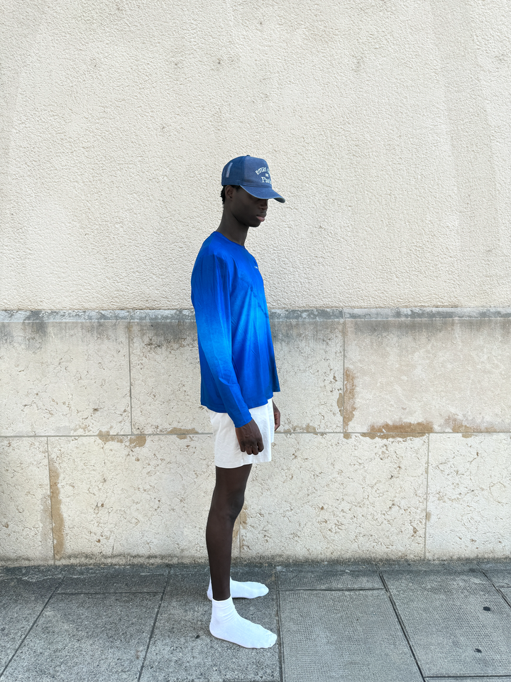 Washed Indigo Mesh Cap by Lievre Running featuring 5 panels and adjustable snapback with vintage Notre-Dame de Paris design.