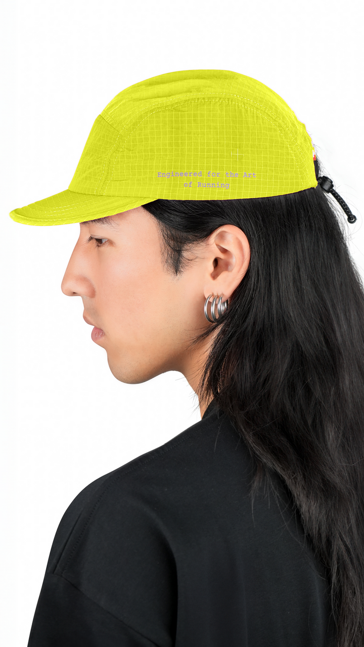 Lievre Running yellow performance running cap, lightweight technical fabric with adjustable back cord and “Engineered for the Art of Running” text on the side panel.