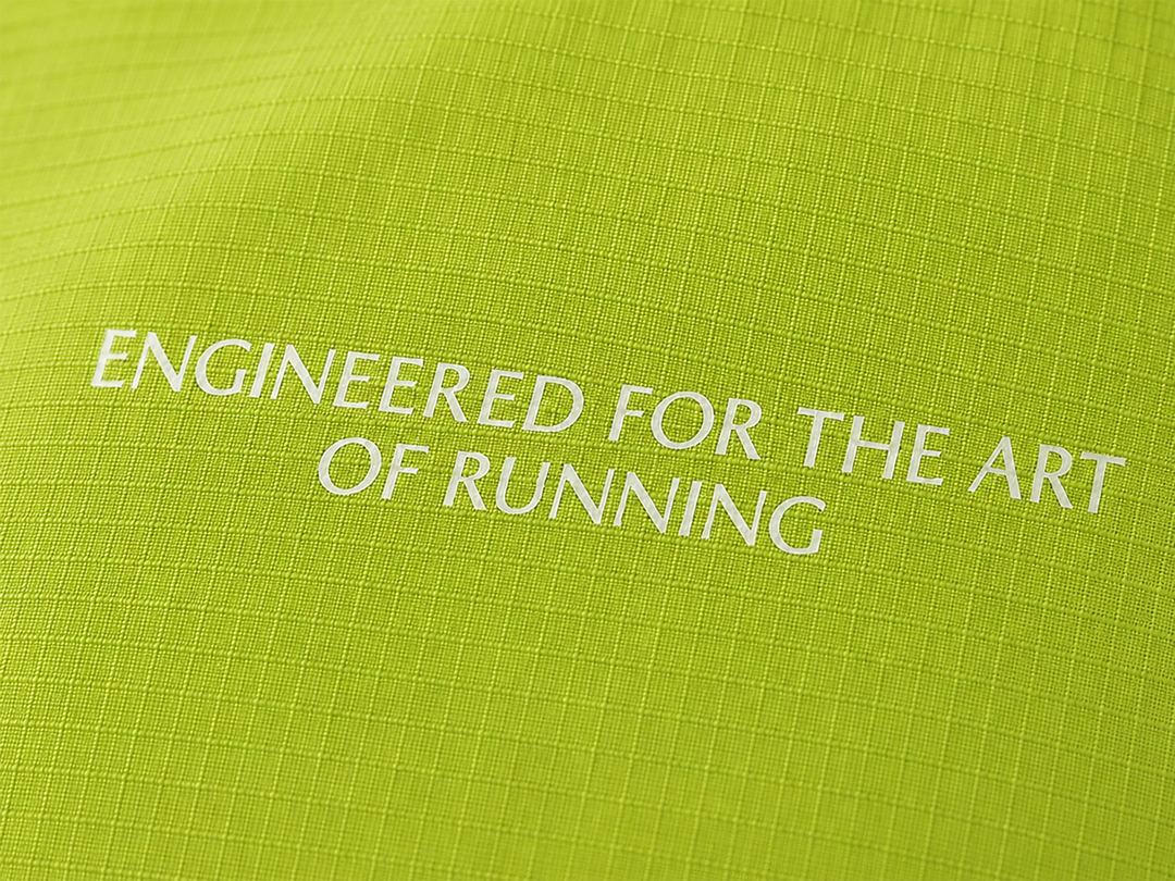 Lievre Running apple green performance running cap, lightweight technical fabric with adjustable back cord and "Engineered for the Art of Running" text on the side panel.