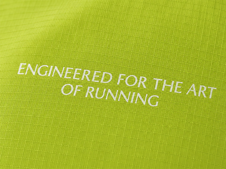 Lievre Running apple green performance running cap, lightweight technical fabric with adjustable back cord and "Engineered for the Art of Running" text on the side panel.