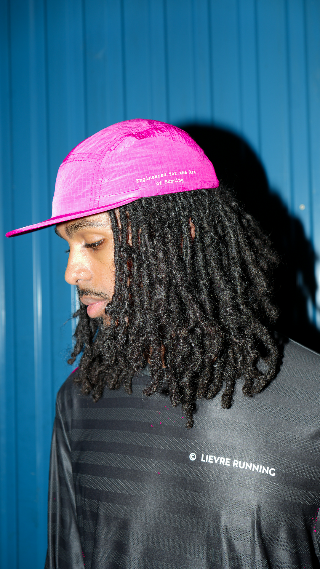 Lievre Running pink performance running cap, lightweight technical fabric with adjustable back cord and “Engineered for the Art of Running” text on the side panel.