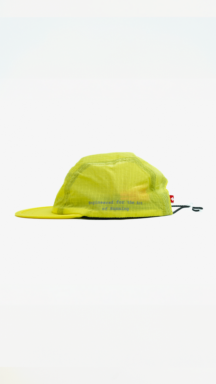 Lievre Running yellow performance running cap, lightweight technical fabric with adjustable back cord and “Engineered for the Art of Running” text on the side panel.