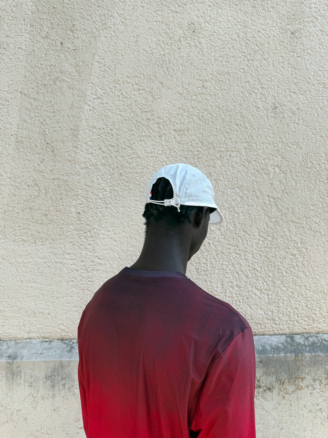Lievre Running Art of Running White Cap showcasing its minimal design and ultra-lightweight fabric, ideal for runners.
