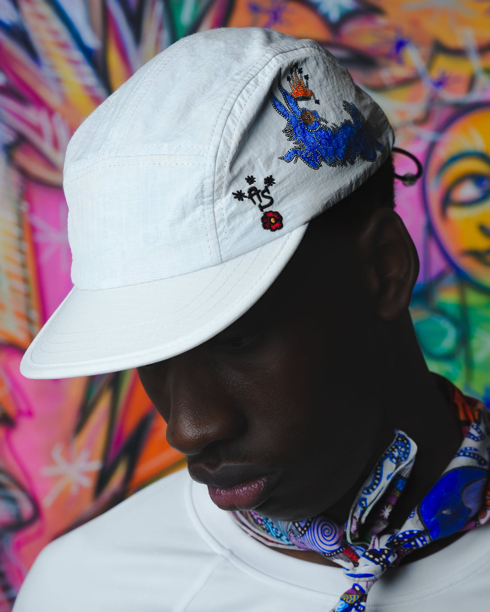 Art of Running performance cap by Lievre Running featuring a vibrant multicolour illustrated pattern by artist Adrien Sabbah, lightweight construction with breathable mesh panels and adjustable fit.