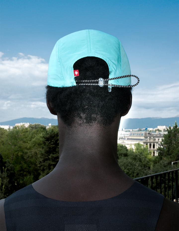 Lievre Running turquoise performance running cap, lightweight technical fabric with adjustable back cord and "Engineered for the Art of Running" text on the side panel.