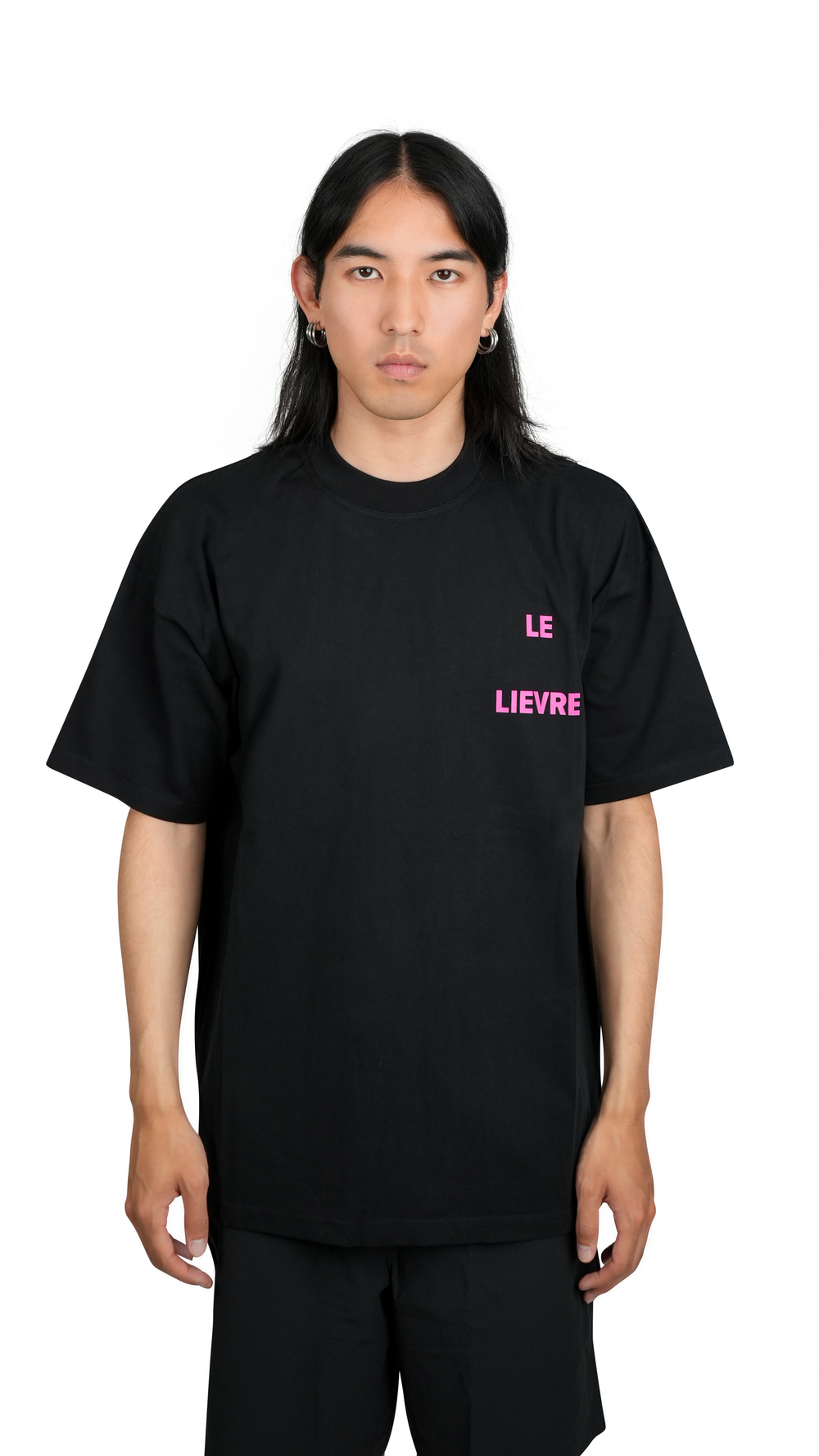 Lievre Running black cotton tee with oversized fit, featuring a bold pink graphic of a running hare on the back and subtle script detail near the hem.