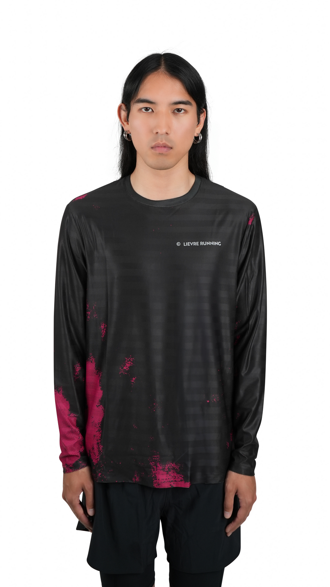 Lievre Running black long sleeve running tee, technical fabric with subtle tonal stripes and pink pixelated graphic accents on sleeves and lower body, white Lievre Running logo on chest.