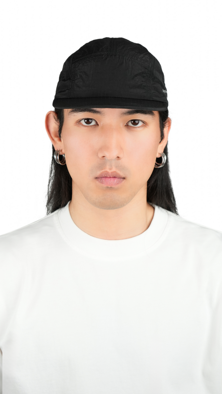 Lievre Running black performance running cap, lightweight technical fabric with adjustable back cord and “Engineered for the Art of Running” text on the side panel.