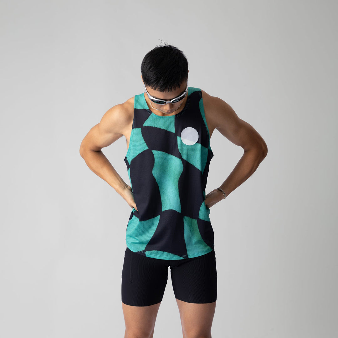 A woman wearing the Green Checker Singlet, showcasing its breathable design and checkered pattern, perfect for running and outdoor activities.