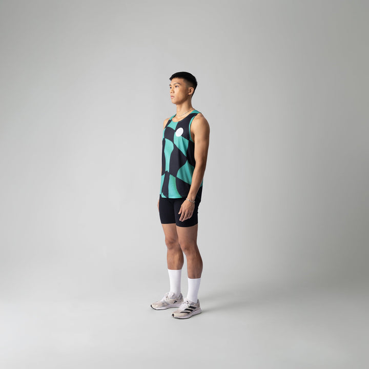 A woman wearing the Green Checker Singlet, showcasing its breathable design and checkered pattern, perfect for running and outdoor activities.