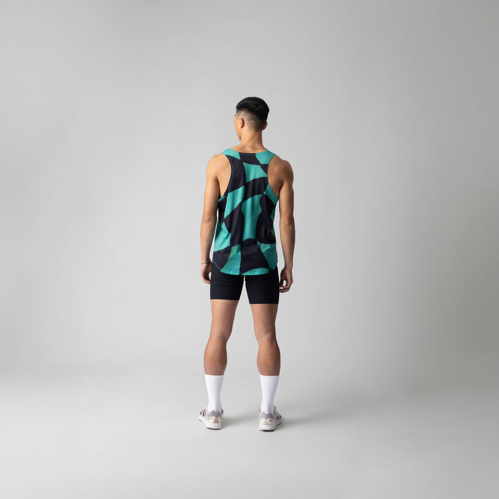 A woman wearing the Green Checker Singlet, showcasing its breathable design and checkered pattern, perfect for running and outdoor activities.