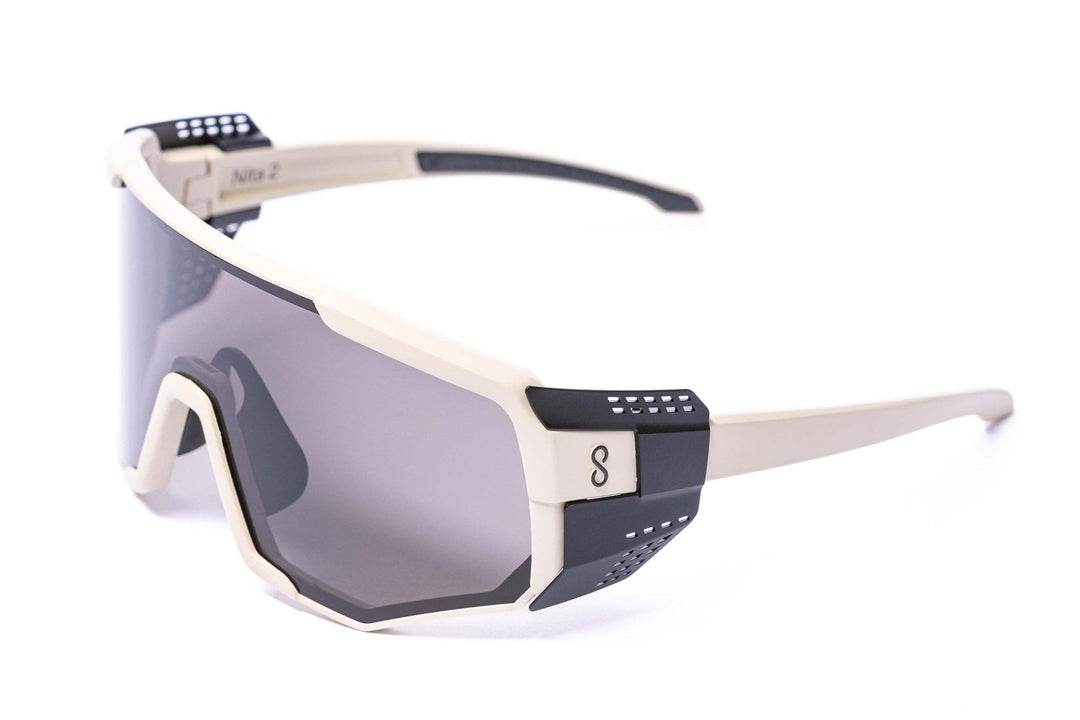 Coast optics Sunglasses with a white frame and dark lenses with glacier shields on a white background 