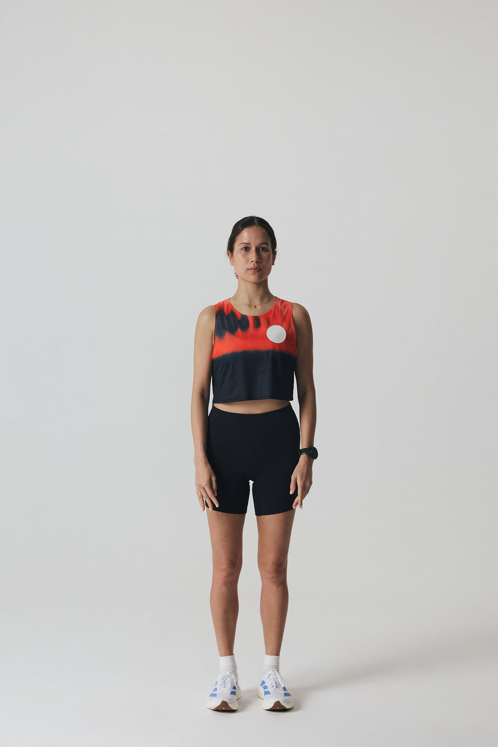 Participation Red Glass running crop top, breathable mesh, red-black gradient, white circle logo on chest.
