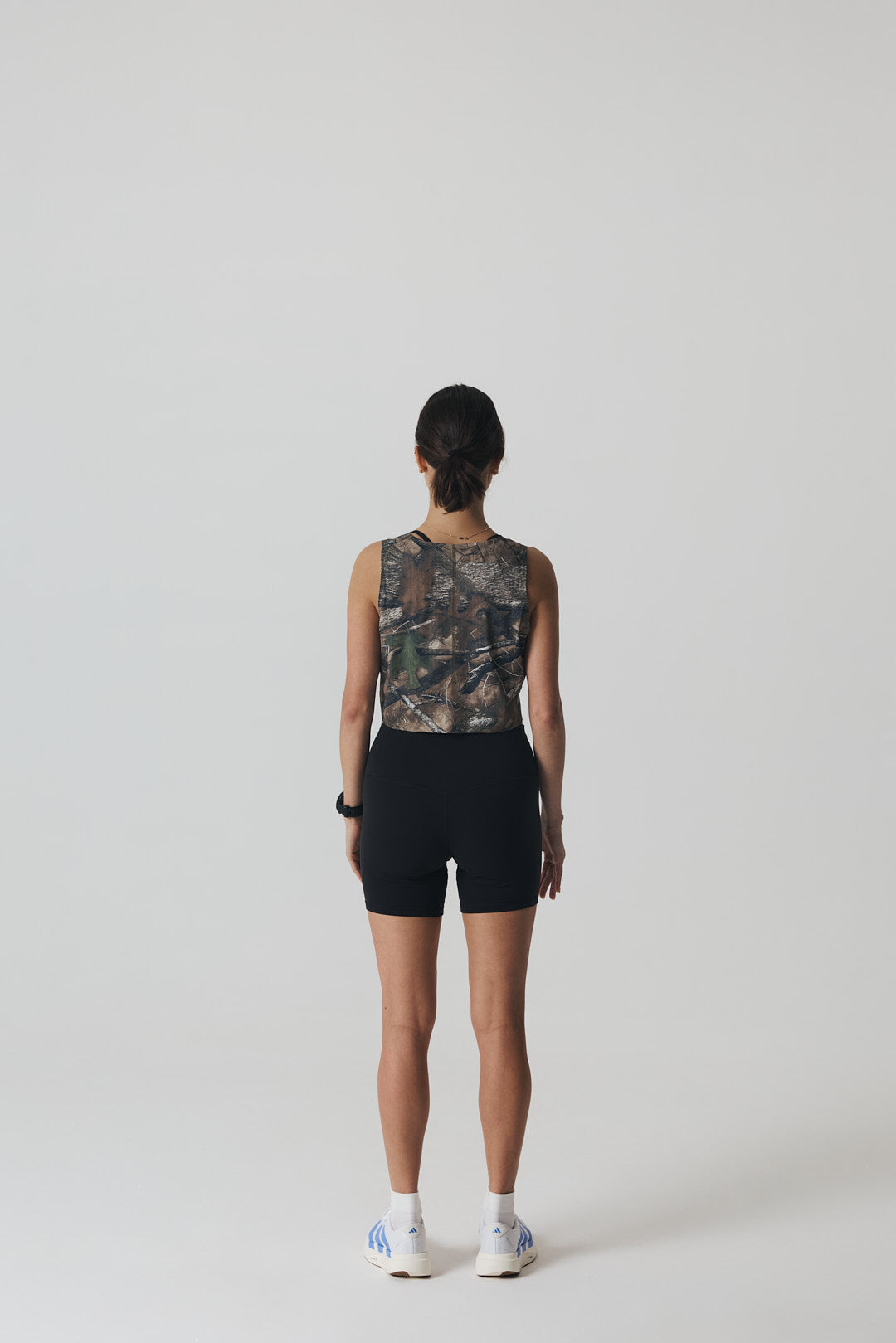Participation Real Tree crop singlet, breathable mesh, camo forest print, white circle logo on chest.