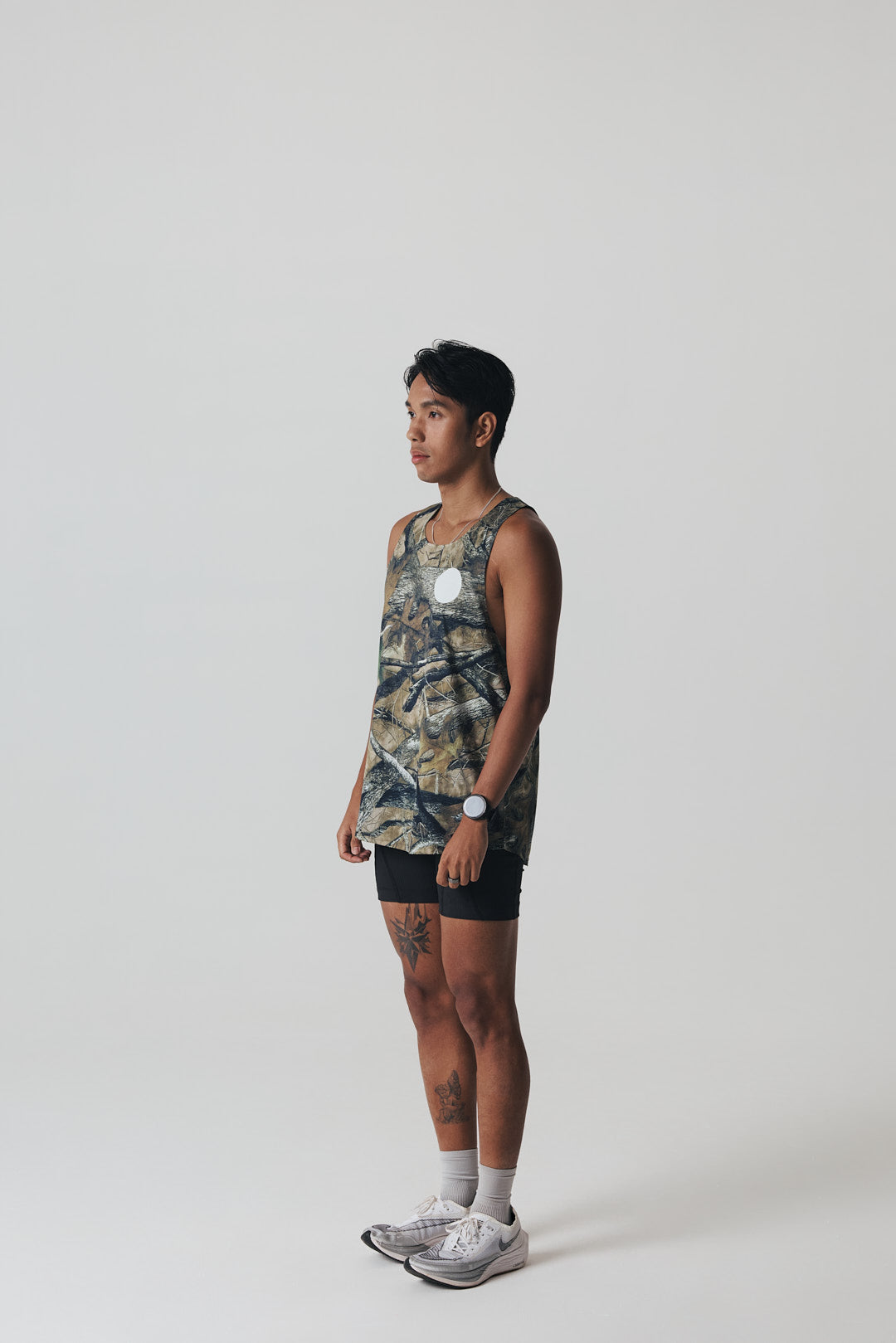 Participation Real Tree singlet, breathable mesh, camo forest print, white circle logo on chest.