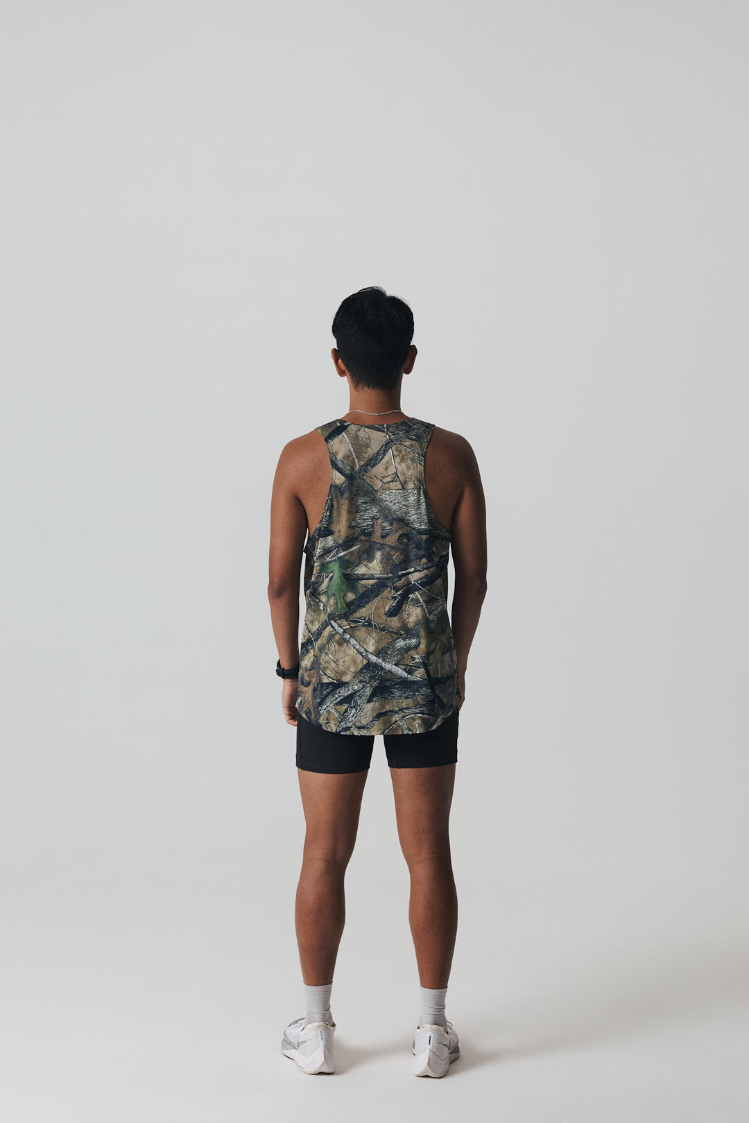 Participation Real Tree singlet, breathable mesh, camo forest print, white circle logo on chest.