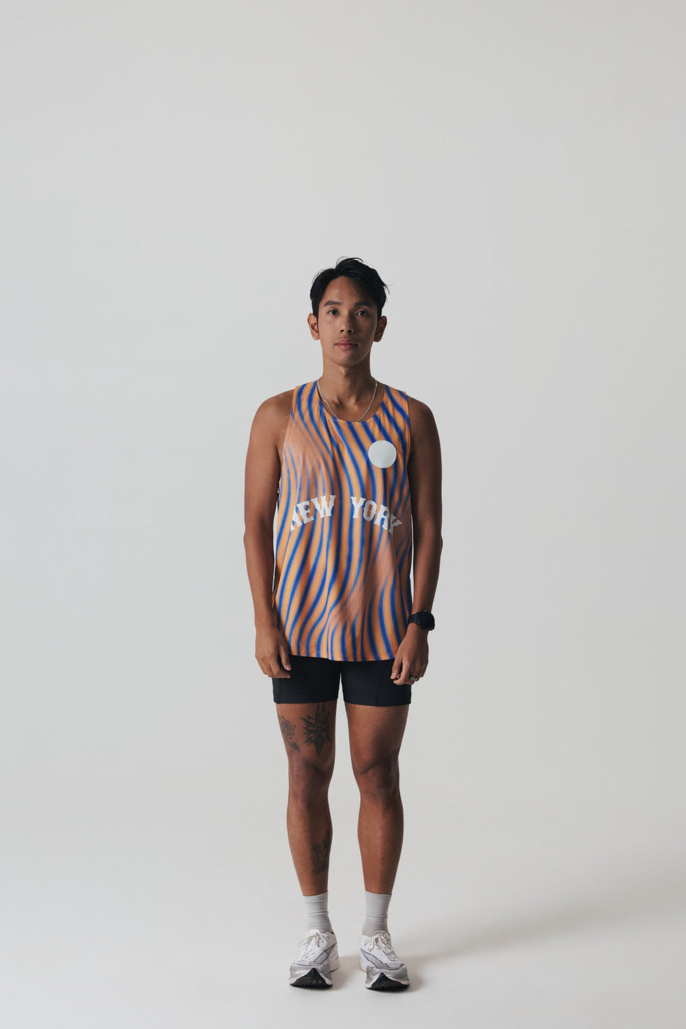 Participation New York singlet, breathable mesh, blue–orange wavy stripes, white circle logo and “NEW YORK” text on front.