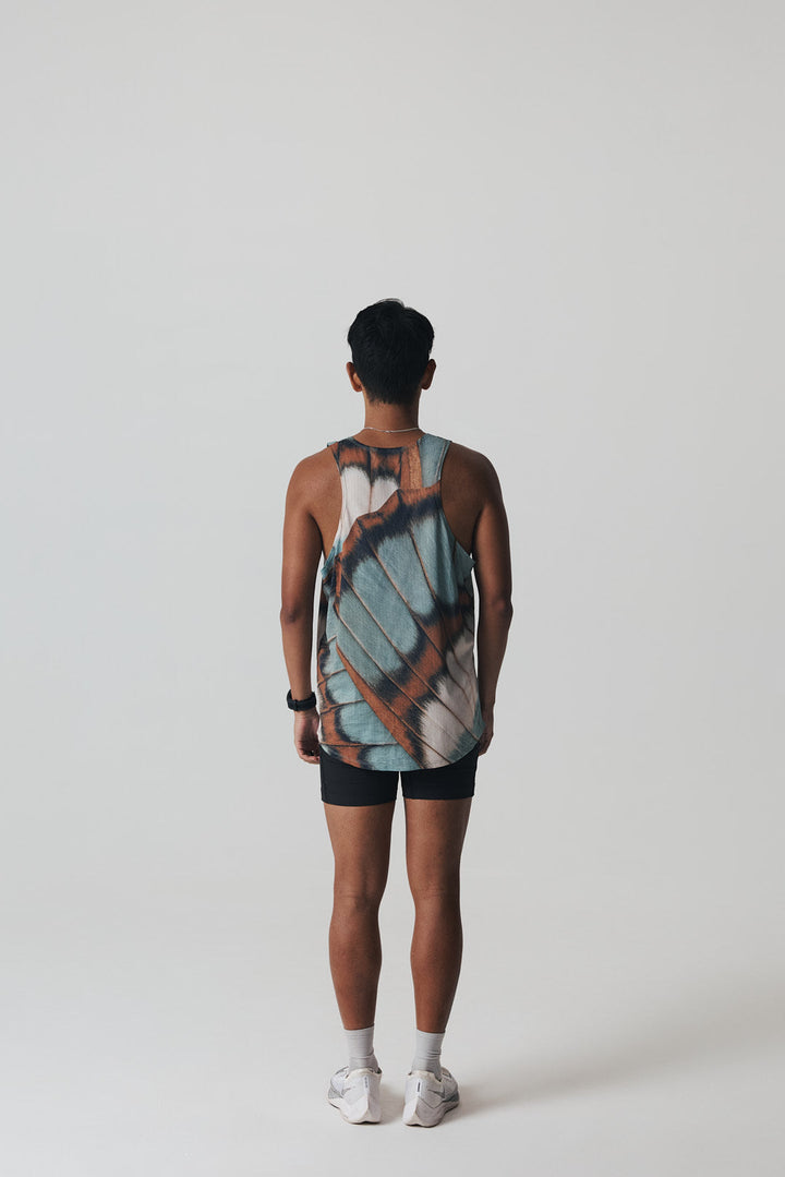 Participation butterfly singlet, breathable mesh, teal–tan wing print, white circle logo on chest.
