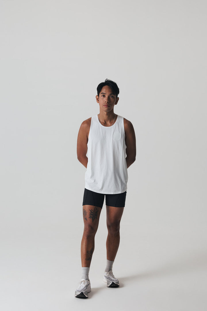 Participation black singlet, breathable mesh, white circle logo on chest.
