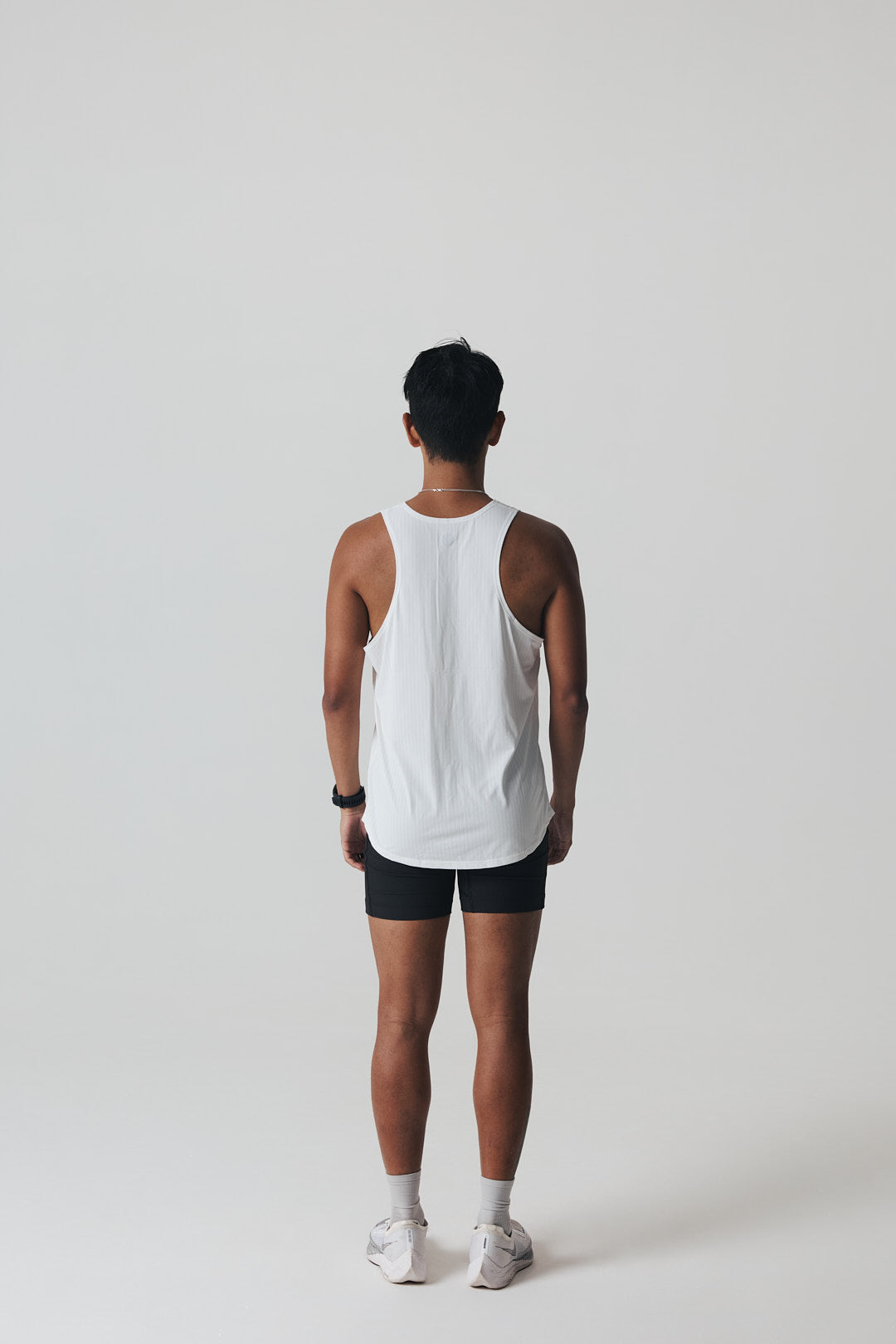 Participation white running singlet, breathable mesh, minimalist plain design, white circle logo on chest.