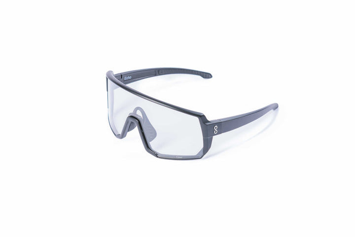 Coast Optics Echo Sunglasses with a clear lens and dark frame on a white background