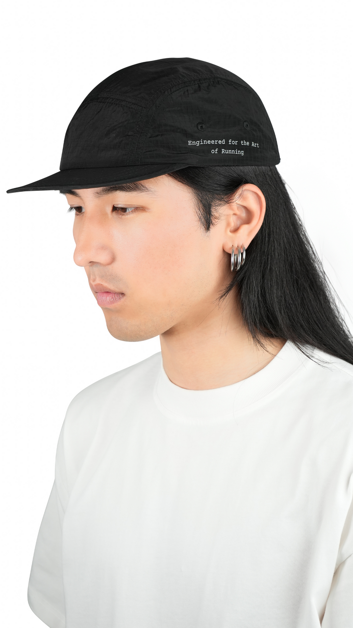 Lievre Running black performance running cap, lightweight technical fabric with adjustable back cord and “Engineered for the Art of Running” text on the side panel.