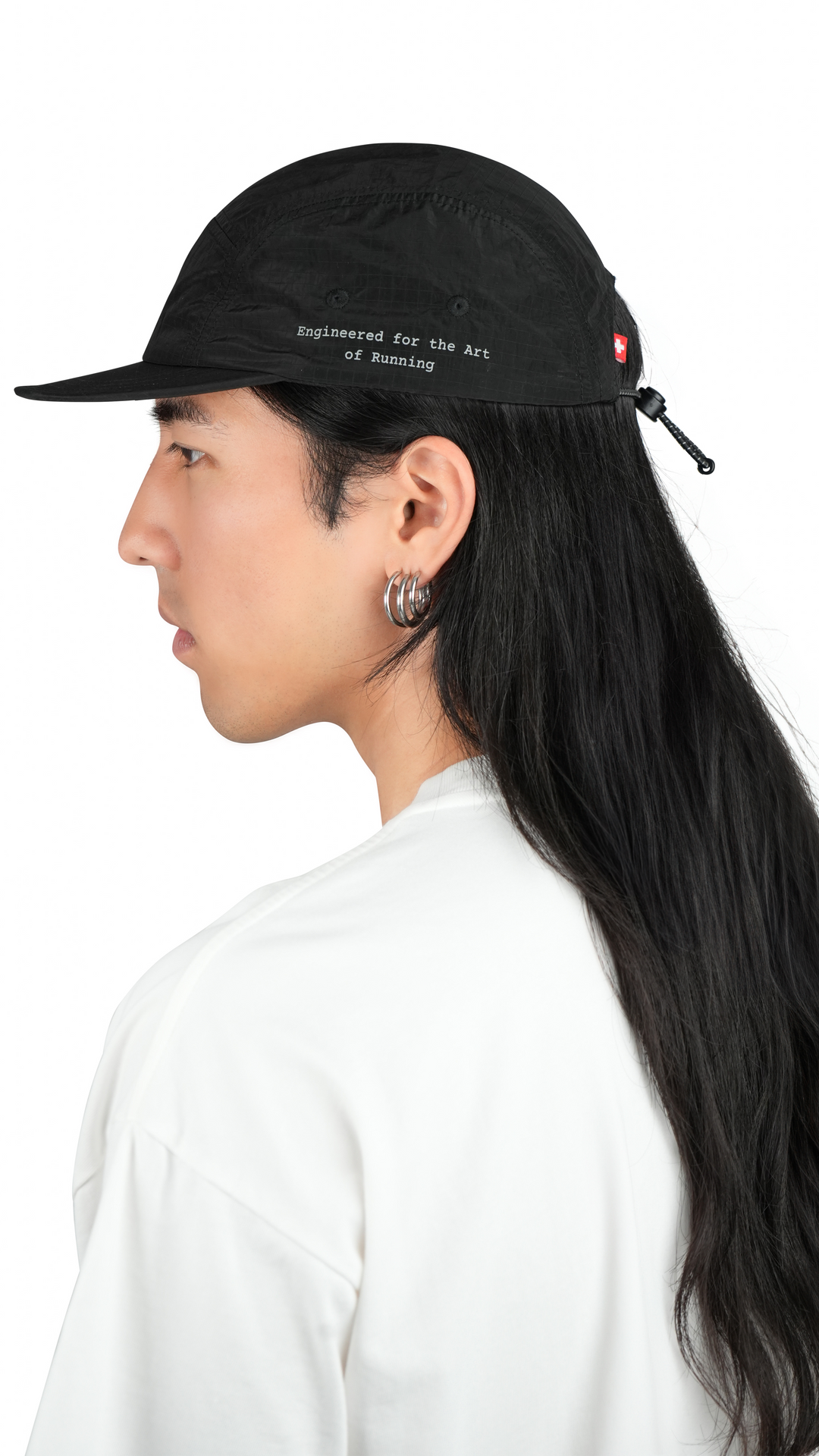 Lievre Running black performance running cap, lightweight technical fabric with adjustable back cord and “Engineered for the Art of Running” text on the side panel.