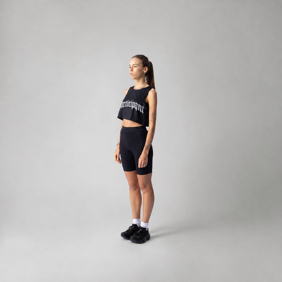Participation Chrome Participant Crop Singlet, a lightweight black workout top designed for comfort and breathability.