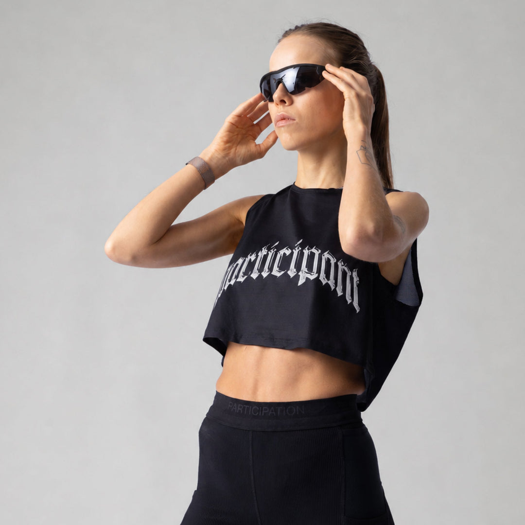 Participation Chrome Participant Crop Singlet, a lightweight black workout top designed for comfort and breathability.