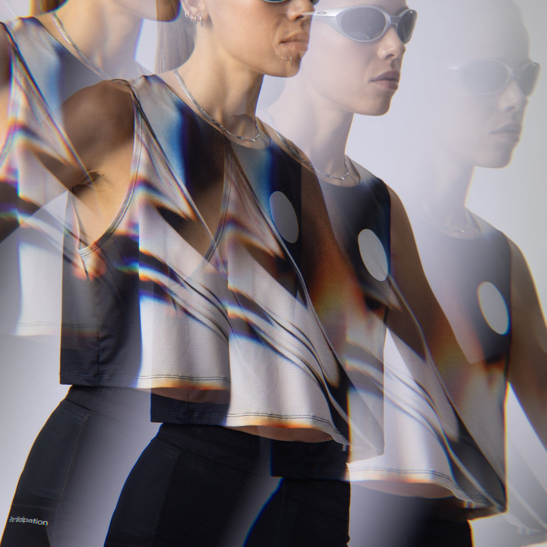 Front view of the Participation White Glass Crop Singlet showcasing its unique design.