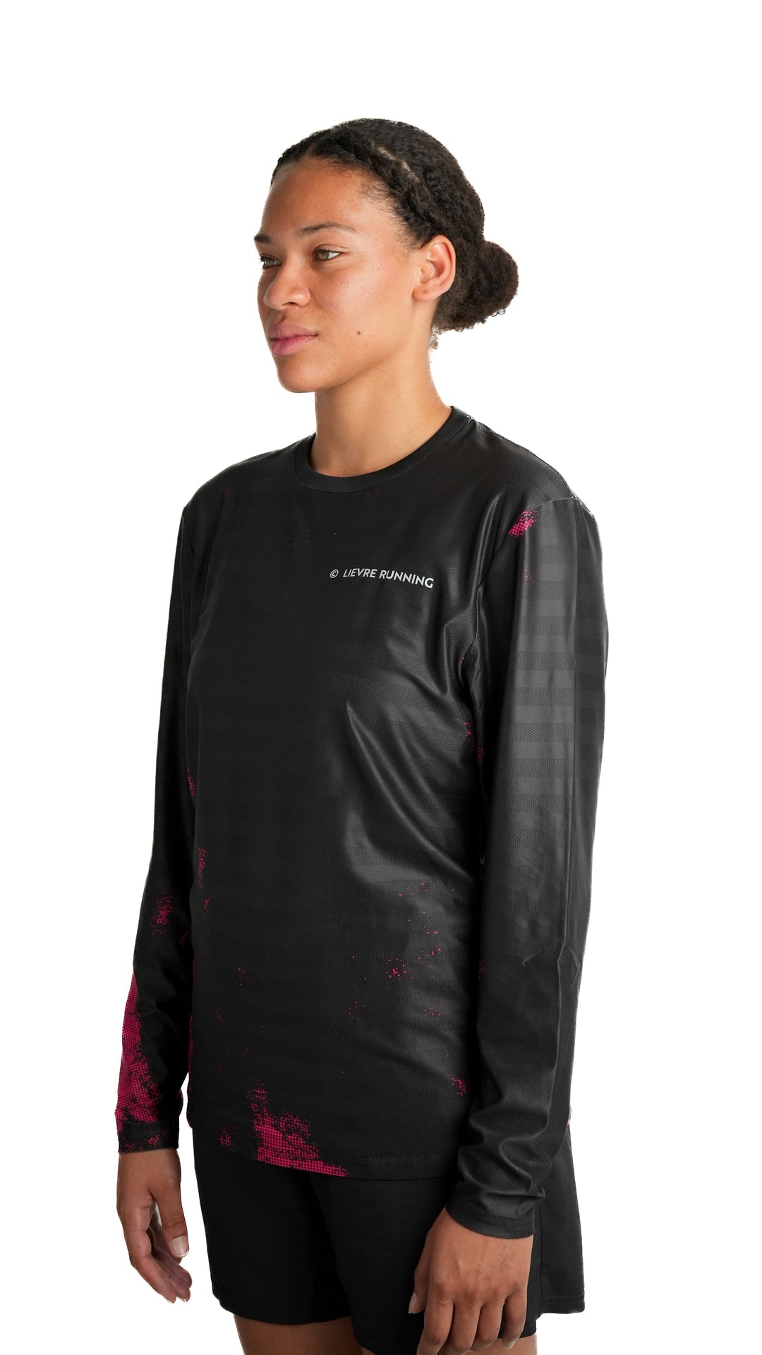 Lievre Running black long sleeve running tee, technical fabric with subtle tonal stripes and pink pixelated graphic accents on sleeves and lower body, white Lievre Running logo on chest.