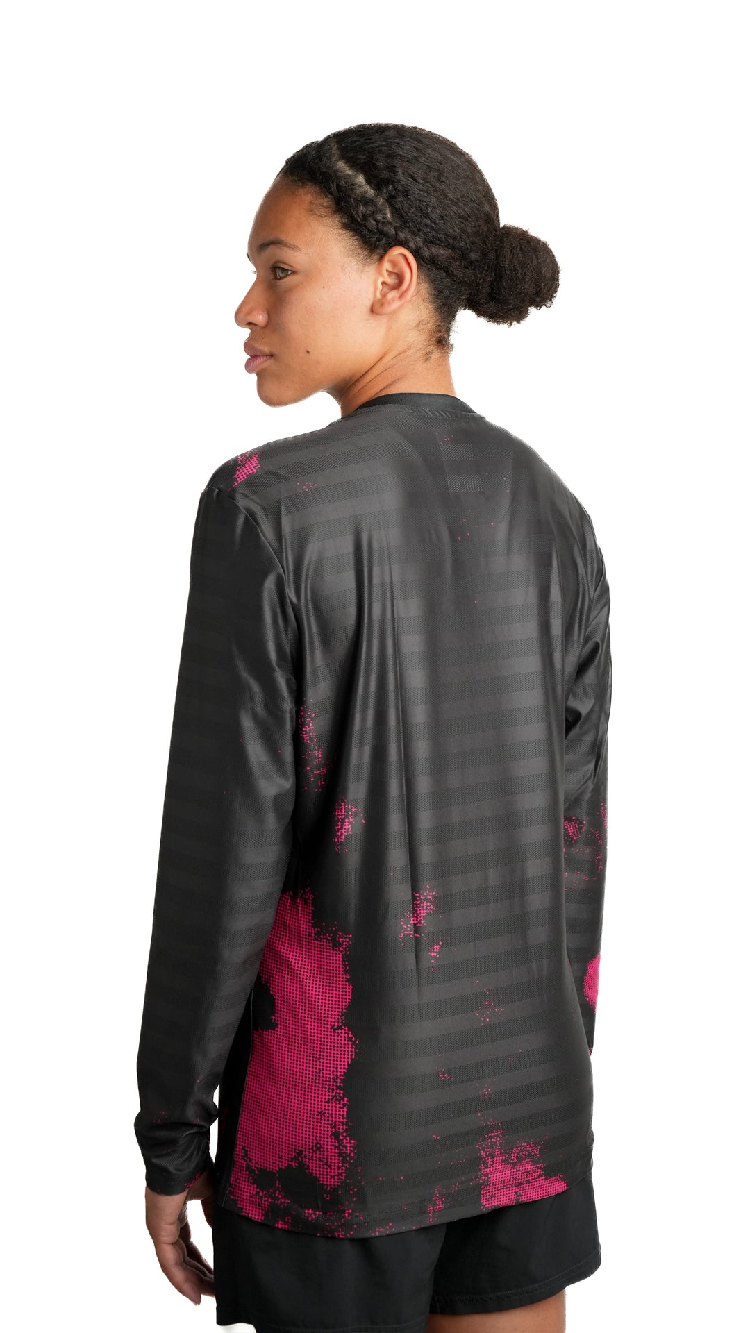 Lievre Running black long sleeve running tee, technical fabric with subtle tonal stripes and pink pixelated graphic accents on sleeves and lower body, white Lievre Running logo on chest.