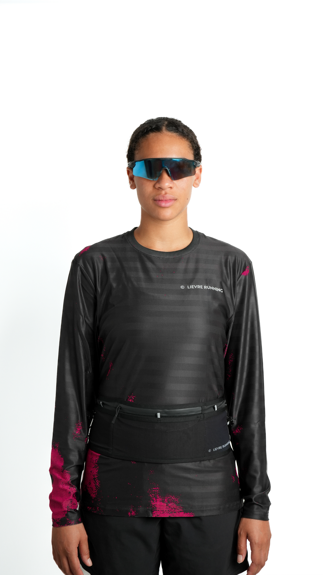 Lievre Running black ultra running belt, stretch technical fabric with multiple compartments, bungee cord system and white Lievre Running logo on front and back.