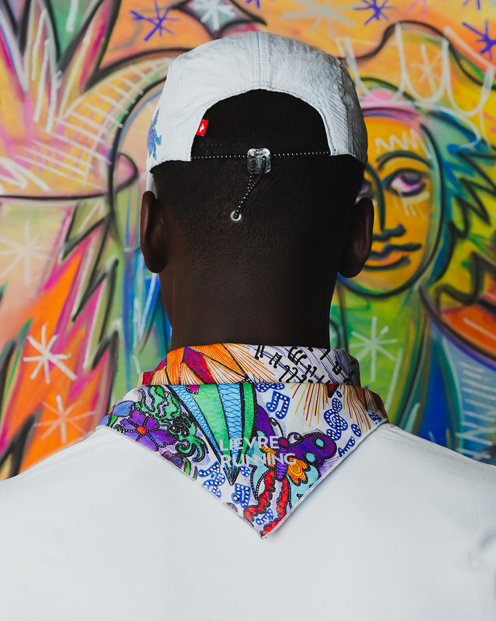 Art of Running performance cap by Lievre Running featuring a vibrant multicolour illustrated pattern by artist Adrien Sabbah, lightweight construction with breathable mesh panels and adjustable fit.