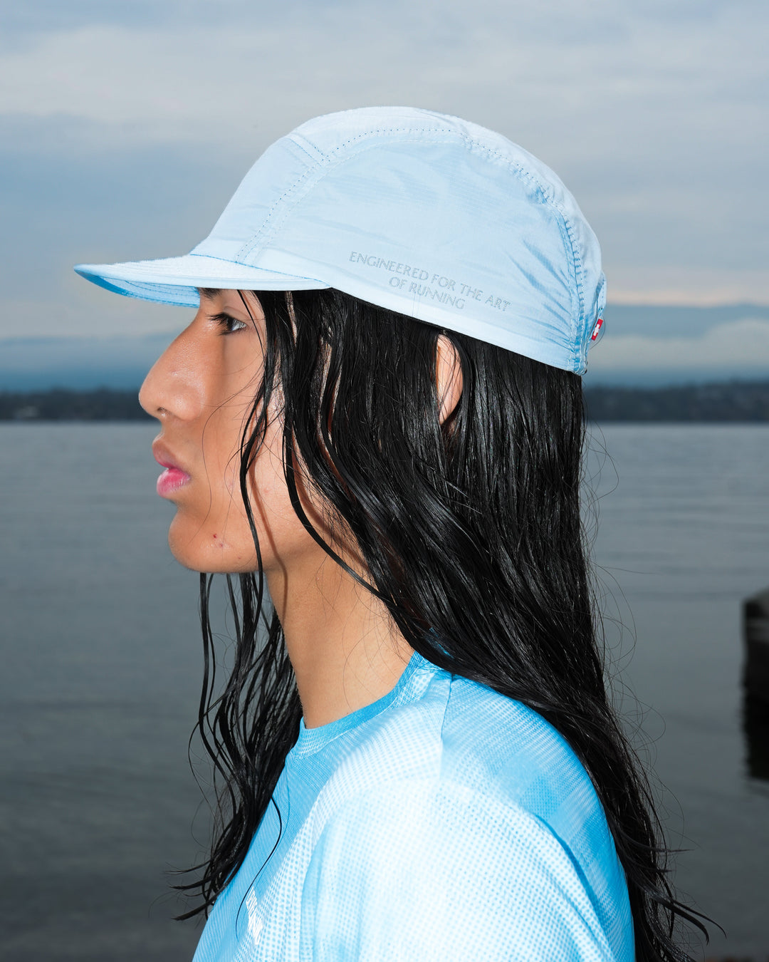 Lievre Running Art of Running Light Blue Cap, lightweight breathable technical fabric with adjustable strap, fresh light blue colorway for running and trail.