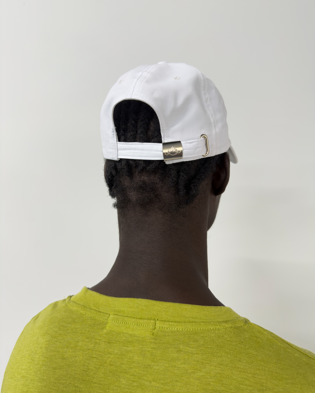 Lievre Running Signature White Cap, ultra-lightweight technical nylon construction with minimal design and adjustable back cord.