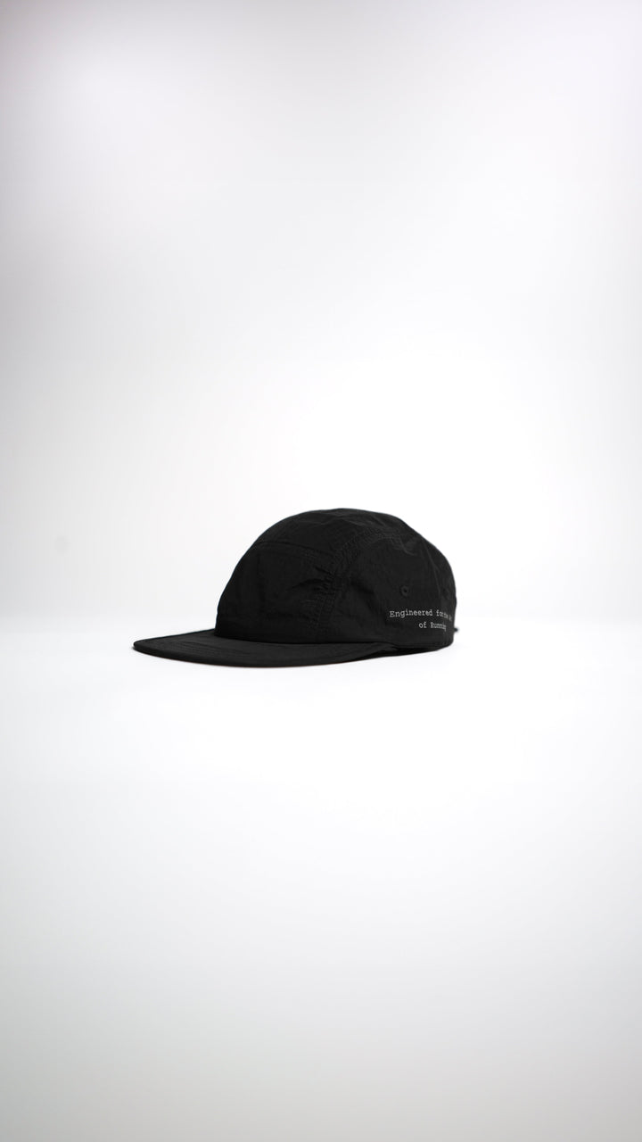 Lievre Running black performance running cap, lightweight technical fabric with adjustable back cord and “Engineered for the Art of Running” text on the side panel.