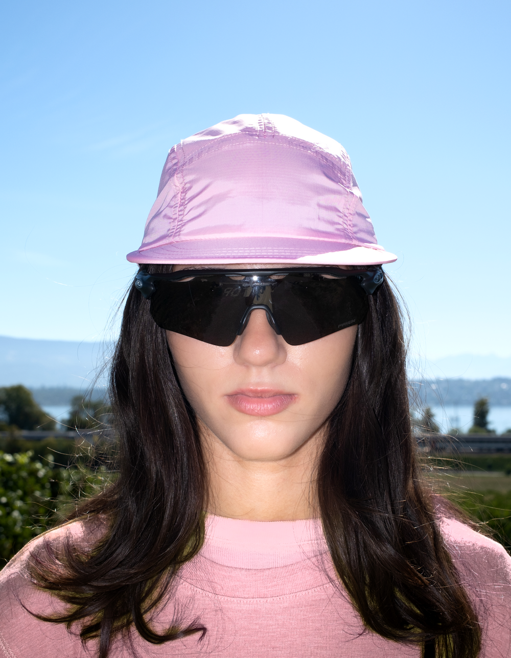 Lievre Running soft pink performance running cap, lightweight technical fabric with adjustable back cord and "Engineered for the Art of Running" text on the side panel.