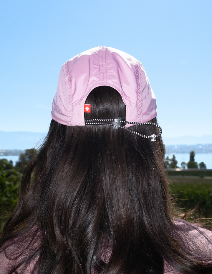 Lievre Running soft pink performance running cap, lightweight technical fabric with adjustable back cord and "Engineered for the Art of Running" text on the side panel.