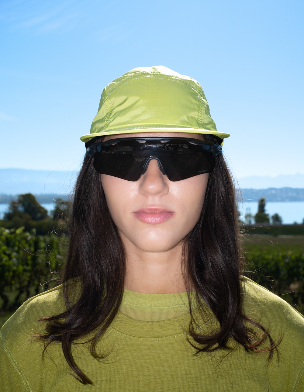 Lievre Running apple green performance running cap, lightweight technical fabric with adjustable back cord and "Engineered for the Art of Running" text on the side panel.