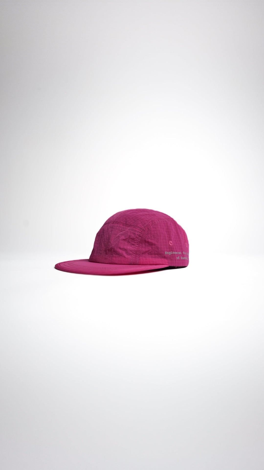 Lievre Running pink performance running cap, lightweight technical fabric with adjustable back cord and “Engineered for the Art of Running” text on the side panel.