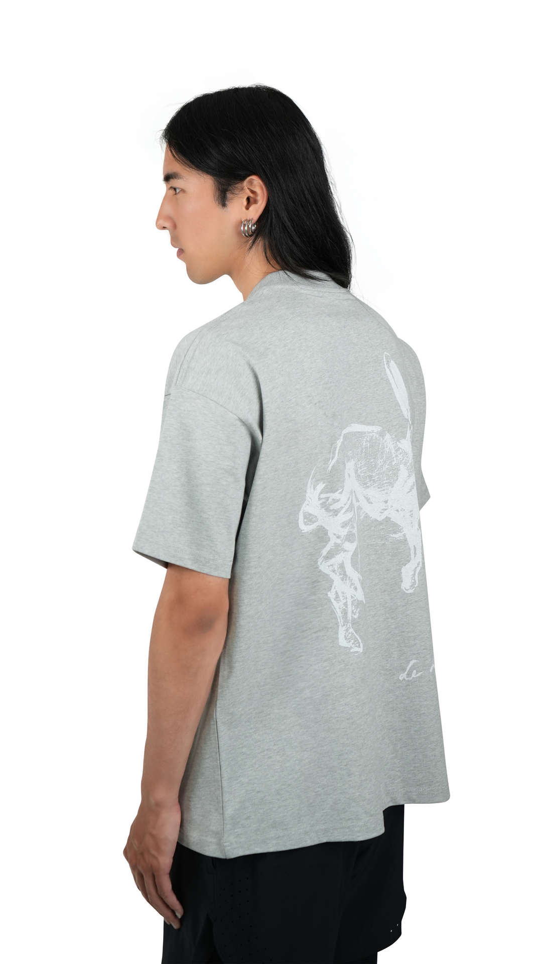 Lievre Running grey cotton tee with relaxed fit, featuring a large white graphic of a running hare on the back and subtle script detail near the hem.