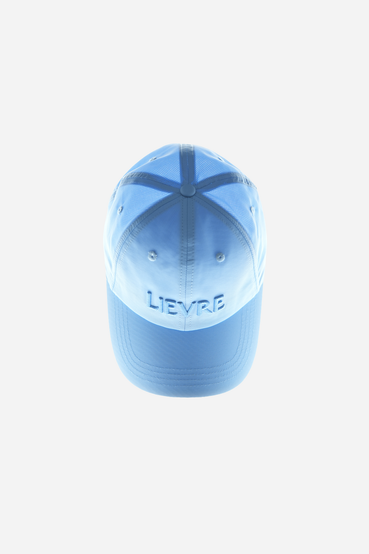 Lievre Running Signature Haze Blue Cap, ultra-lightweight nylon construction with DWR waterproof finish and minimal design, adjustable back strap.
