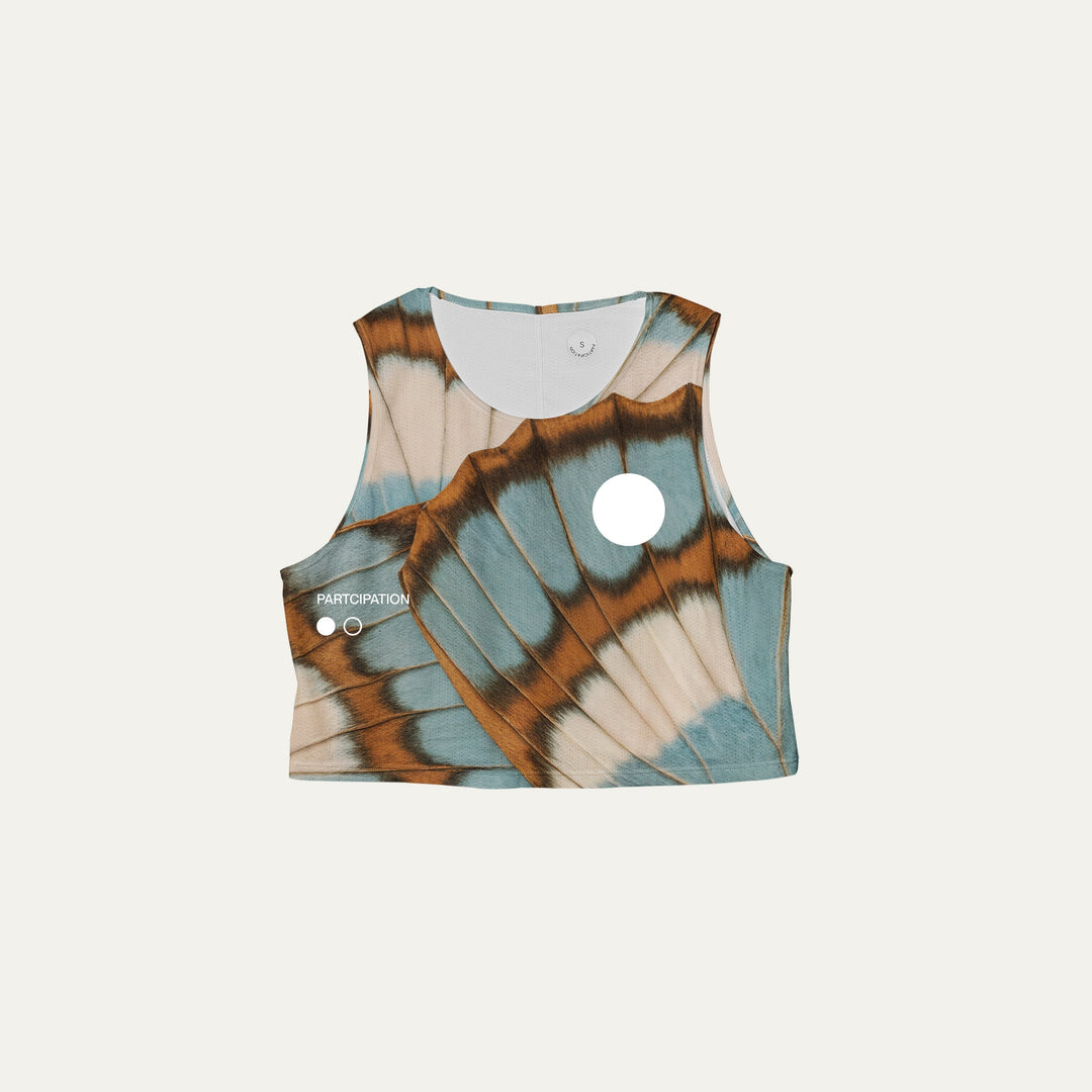 Participation butterfly crop singlet, breathable mesh, teal–tan wing print, white circle logo on chest.