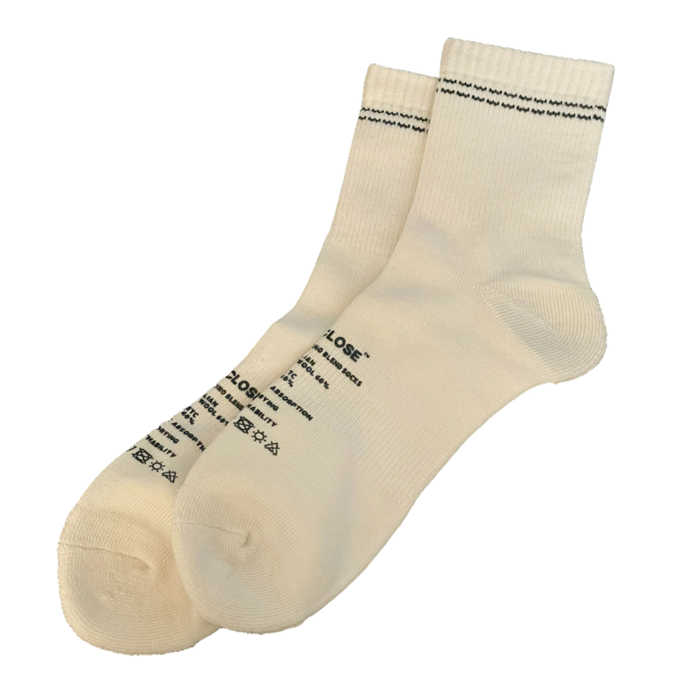 White DISCLOSE 001 merino blend running socks made from soft, breathable merino wool blend fabric