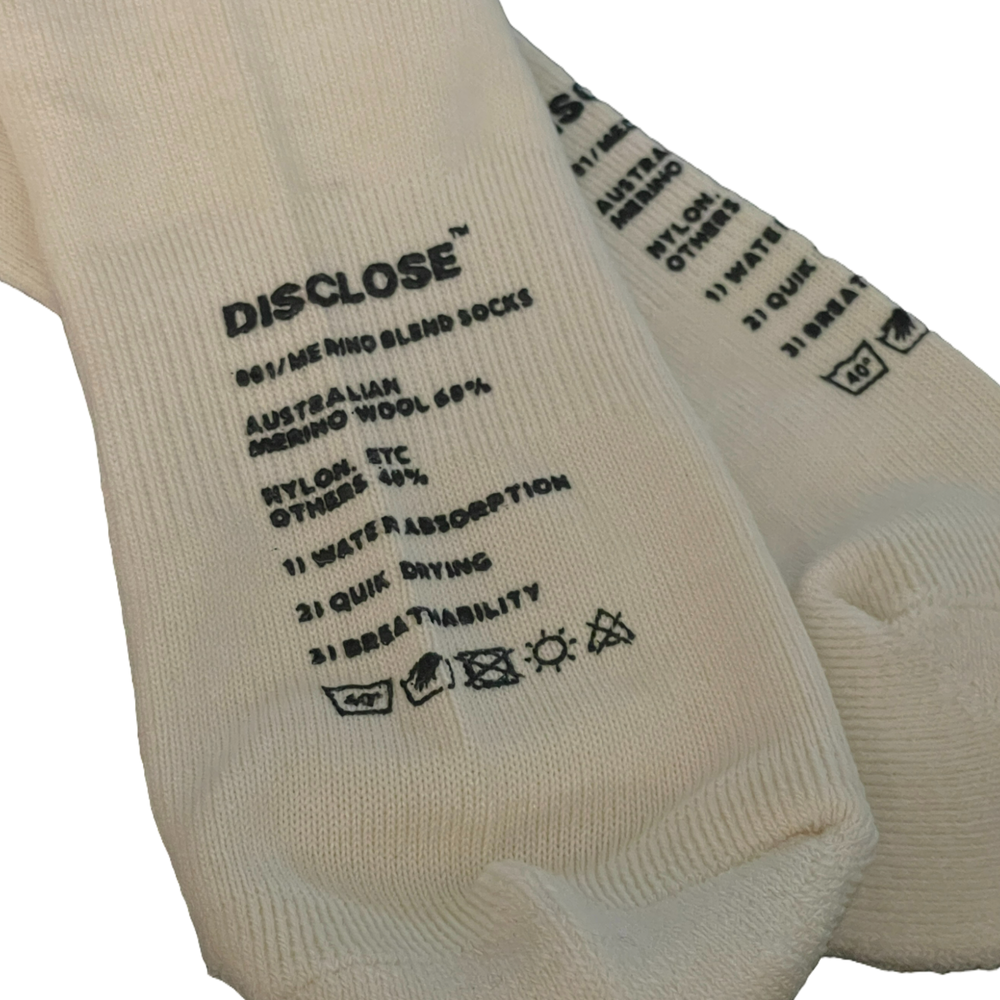 White DISCLOSE 001 merino blend running socks made from soft, breathable merino wool blend fabric
