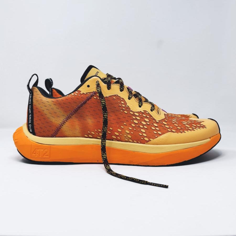 4T2 one more running shoe in orange, featuring a breathable upper and a durable rubber outsole designed for speed and traction.