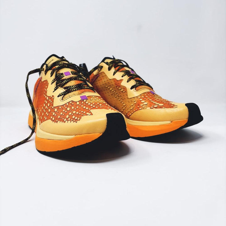 4T2 one more running shoe in orange, featuring a breathable upper and a durable rubber outsole designed for speed and traction.